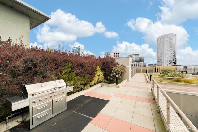 view of patio with a city view and a grill