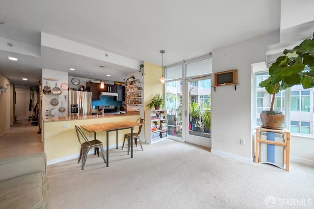 dining space featuring light carpet, baseboards, and recessed lighting