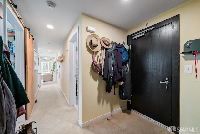 hall featuring recessed lighting, light carpet, and baseboards