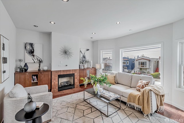 living room featuring light hardwood / wood-style flooring and a tile fireplace