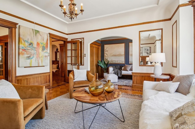3011 Van Ness Ave, San Francisco, CA 94109 - living room with arched walkways, a wainscoted wall, a chandelier, and ornamental molding