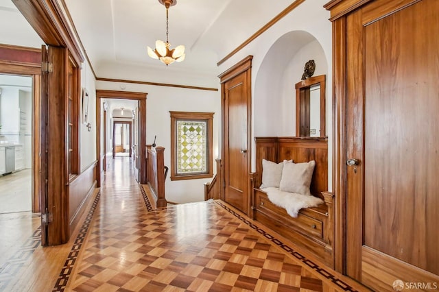 3011 Van Ness Ave, San Francisco, CA 94109 - hall featuring a chandelier, wainscoting, and crown molding