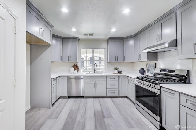 95 Olmsted Ct, Pittsburg, CA 94565 - kitchen featuring stainless steel appliances, under cabinet range hood, gray cabinets, light countertops, and recessed lighting