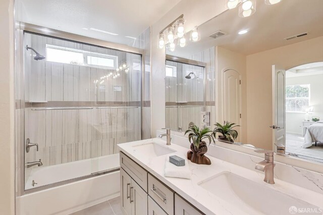 95 Olmsted Ct, Pittsburg, CA 94565 - ensuite bathroom with bath / shower combo with glass door, double vanity, healthy amount of natural light, and tile patterned floors