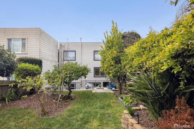 rear view of property with a lawn and a patio