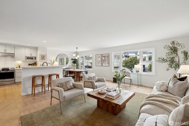 living room featuring light parquet floors and a healthy amount of sunlight