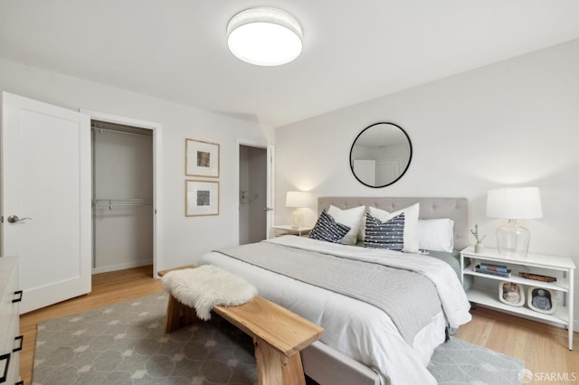 bedroom featuring a closet and light hardwood / wood-style flooring