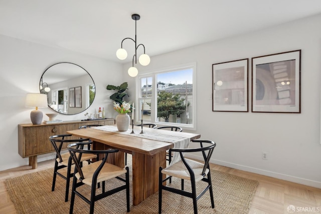 dining area featuring light parquet flooring