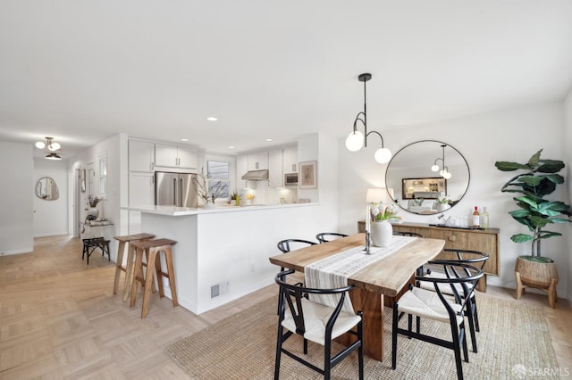 dining space featuring light parquet floors