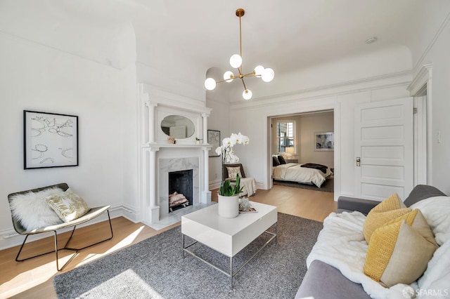 291 Church St, San Francisco, CA 94114 - living area with wood finished floors, a chandelier, a fireplace, and crown molding
