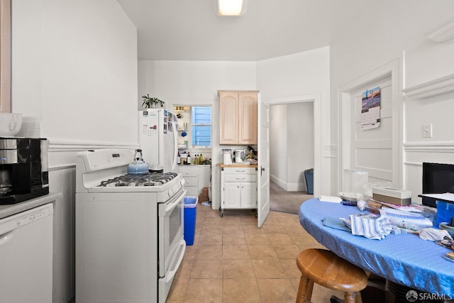 kitchen featuring light tile patterned floors and white appliances