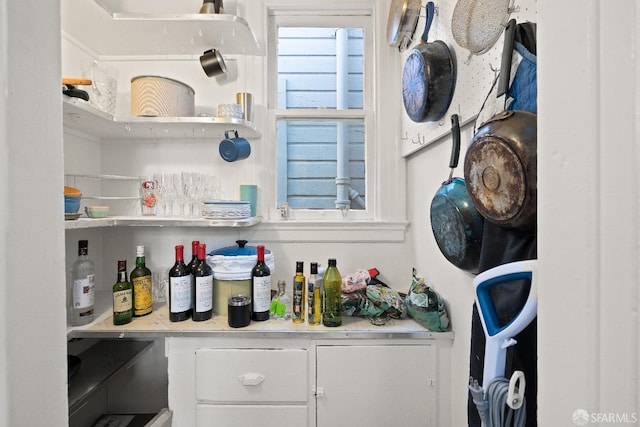 bar featuring white cabinets