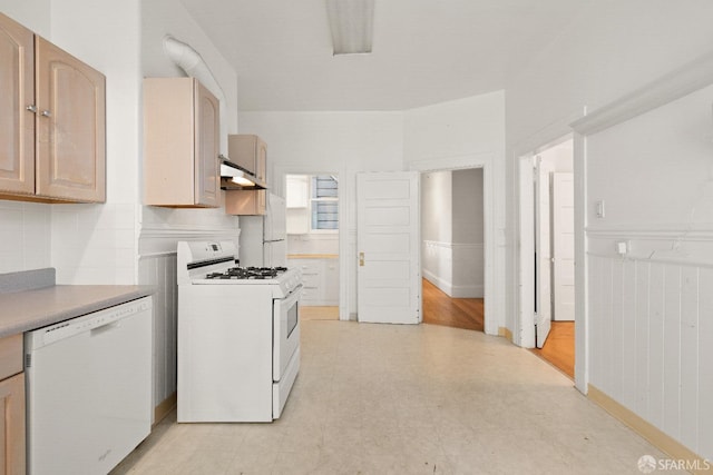 kitchen with white appliances and light brown cabinets