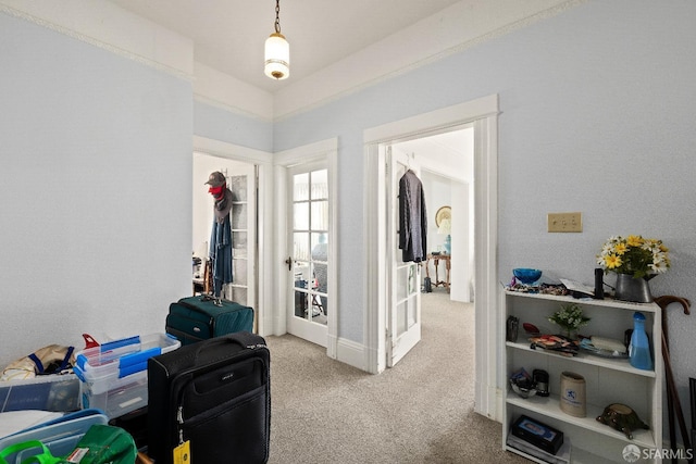 hallway featuring light colored carpet