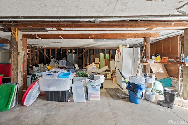 garage with white refrigerator and gas water heater