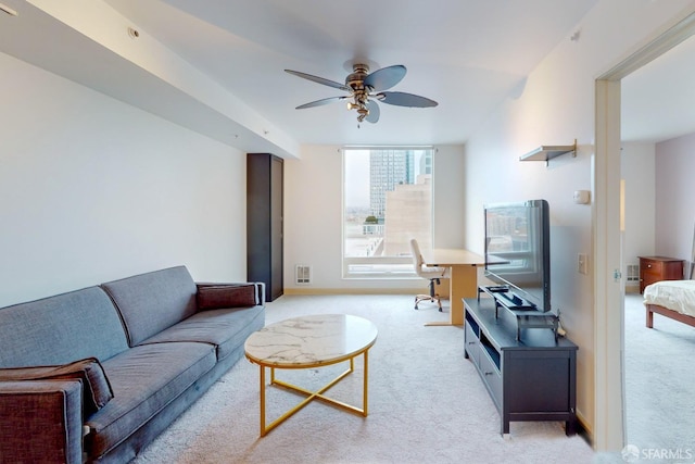 carpeted living room featuring ceiling fan