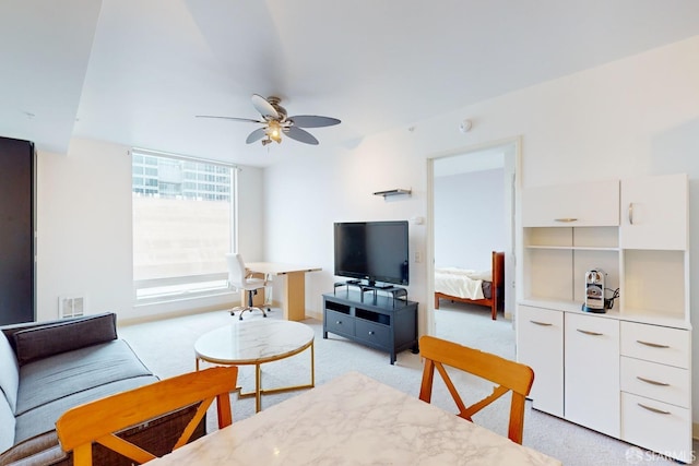 living room featuring light colored carpet and ceiling fan