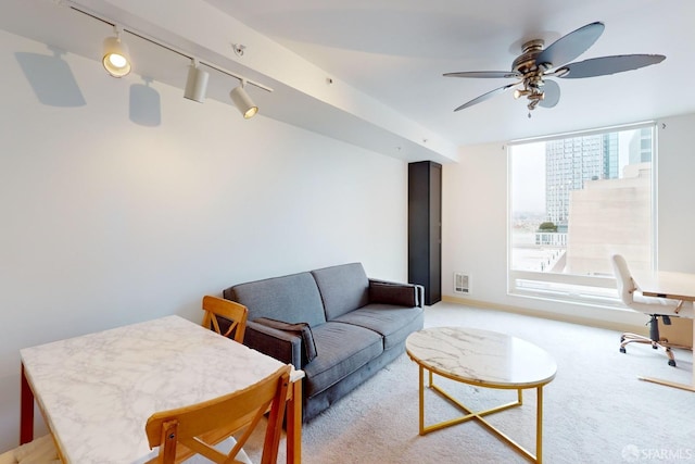 living room with light colored carpet, track lighting, and ceiling fan