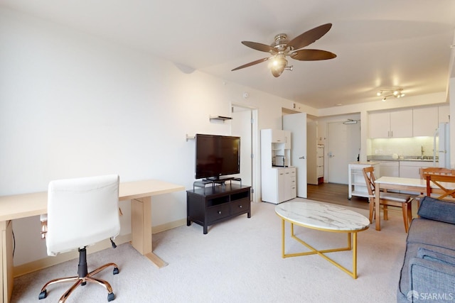 living room with light carpet and ceiling fan