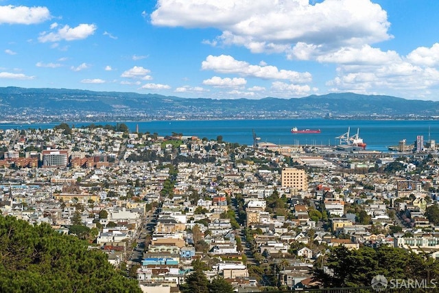 aerial view featuring a water and mountain view