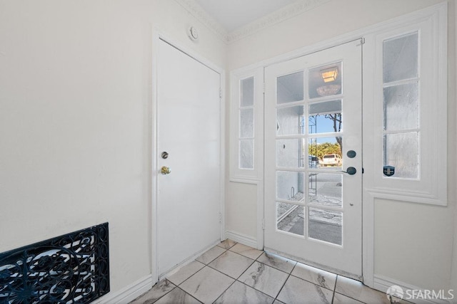 doorway to outside with marble finish floor and baseboards