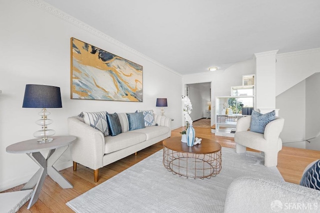 living room featuring wood finished floors and crown molding