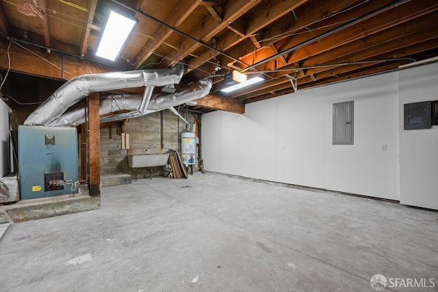 unfinished below grade area featuring water heater, a sink, and electric panel