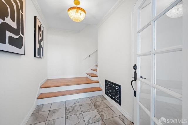 stairway with ornamental molding, marble finish floor, and baseboards