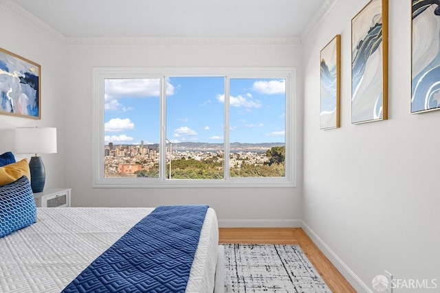 bedroom featuring light wood-type flooring and baseboards