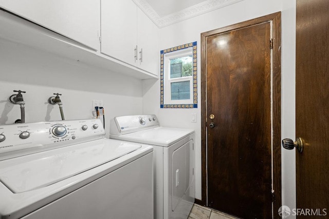 washroom with cabinet space, crown molding, and washer and dryer