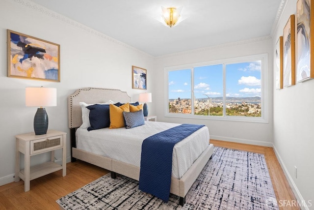 bedroom featuring baseboards and wood finished floors