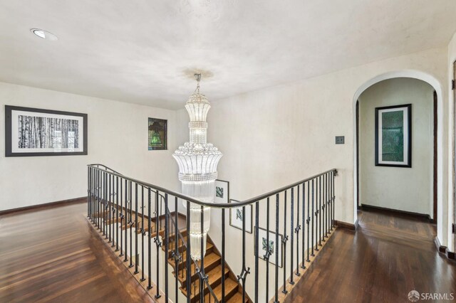 1475 Monterey Blvd, San Francisco, CA 94127 - hallway with arched walkways, baseboards, wood finished floors, and a chandelier