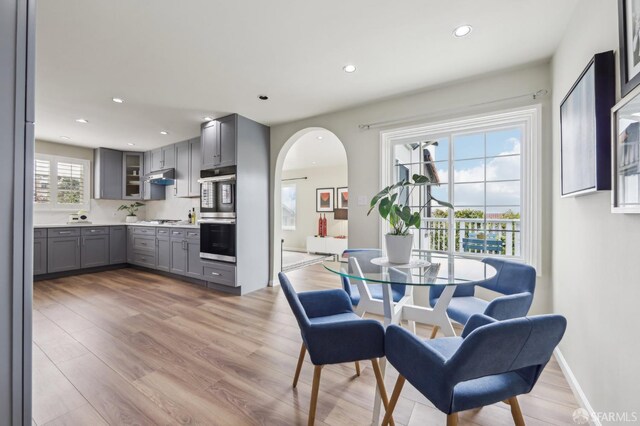 1475 Monterey Blvd, San Francisco, CA 94127 - dining space featuring light wood-style floors, arched walkways, recessed lighting, and baseboards