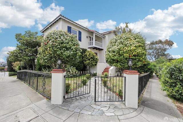 1475 Monterey Blvd, San Francisco, CA 94127 - view of front of home with a fenced front yard, stucco siding, a gate, and a balcony