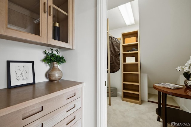 walk in closet featuring light carpet