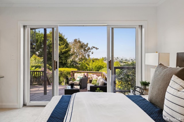 carpeted bedroom featuring crown molding, baseboards, and access to outside