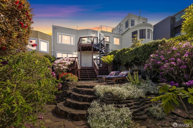 back of house at dusk with stairway