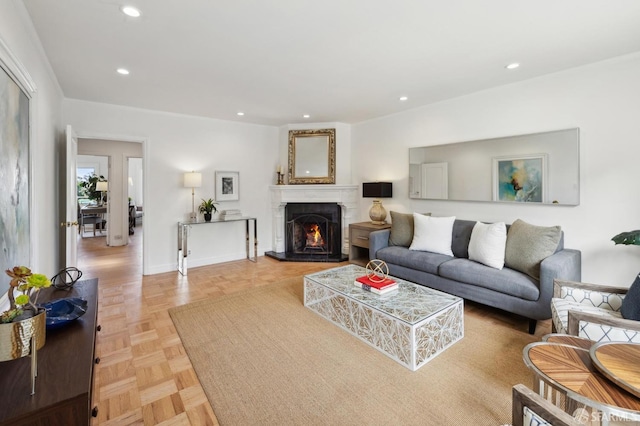 living area featuring a lit fireplace and recessed lighting