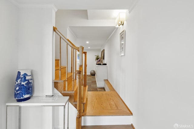 hallway featuring recessed lighting, ornamental molding, and stairway