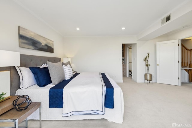bedroom featuring visible vents, baseboards, crown molding, and carpet floors