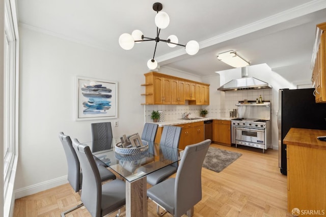 dining room with baseboards, a chandelier, and ornamental molding