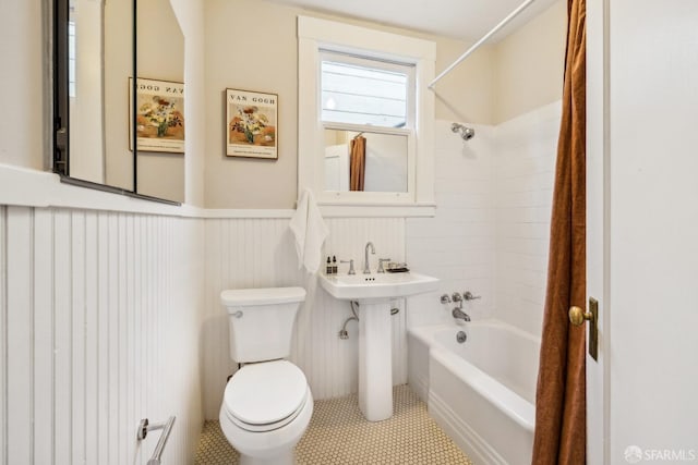 full bathroom with tiled shower / bath, sink, tile patterned floors, and toilet