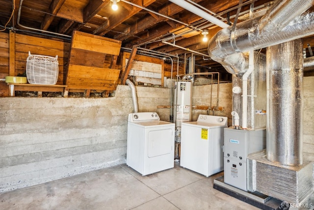 basement with water heater and independent washer and dryer