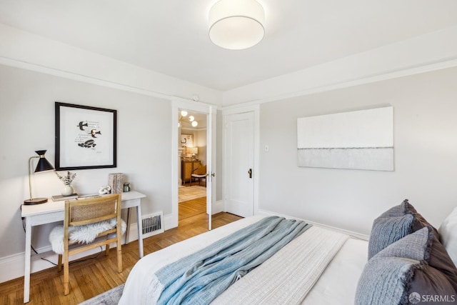 bedroom with hardwood / wood-style flooring