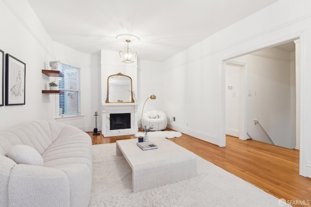 living room featuring hardwood / wood-style flooring and a chandelier