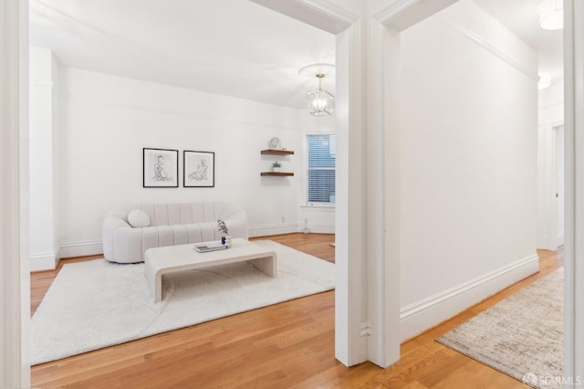 living room featuring wood-type flooring and a notable chandelier