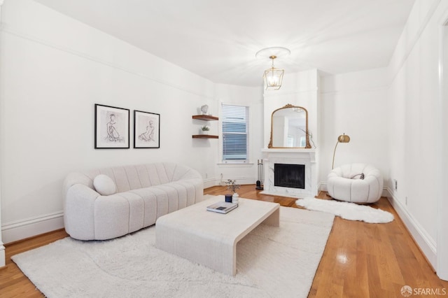 living room featuring wood-type flooring and a chandelier