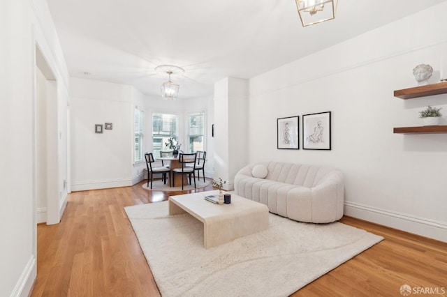 living room with wood-type flooring and a chandelier