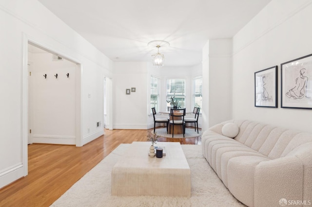 living room featuring hardwood / wood-style flooring and an inviting chandelier