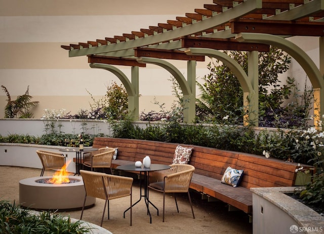 patio terrace at dusk with a pergola and an outdoor fire pit